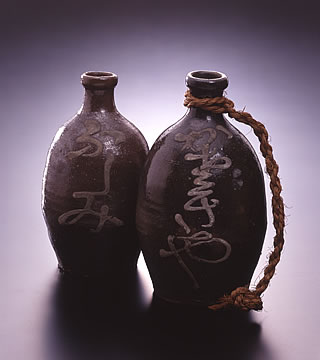 Earthenware sake bottles with ”Fushimi” [left of photo] and “Kasagiya” [right of photo] written on them